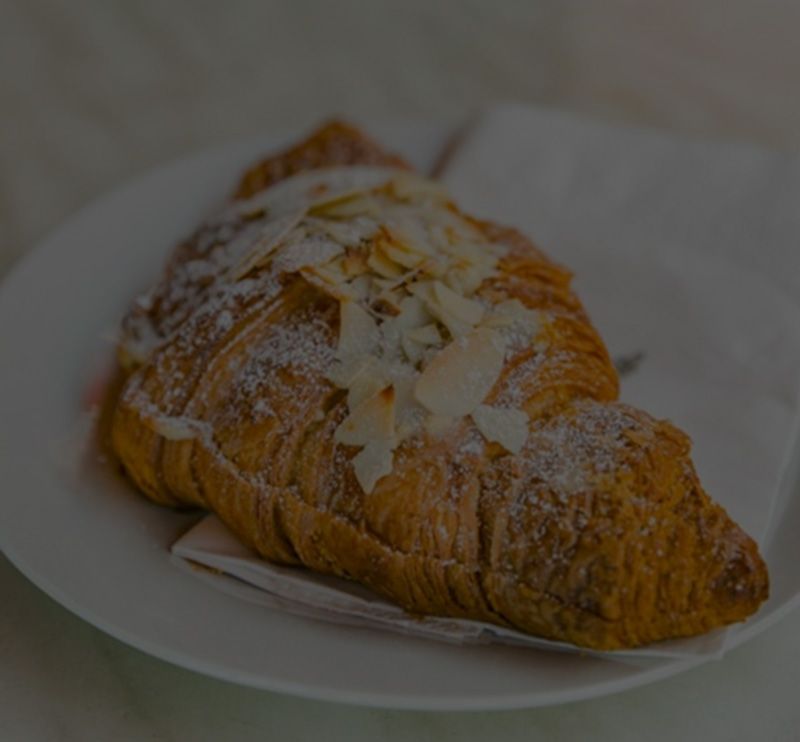 Almond croissant dusted with icing sugar